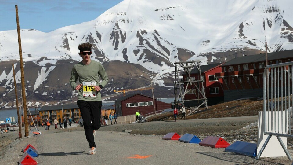 Joseph Buckby løper i mål på halvmaraton i Spitsbergen Marathon 2023
