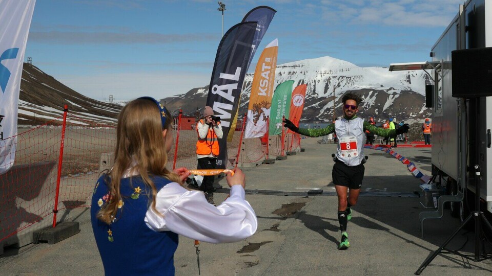Dieter Goegebeur løper i mål som vinner av maratondistansen under Spitsbergen Marathon 2023