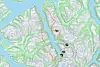 Topografisk kart med en markert rute i oransje og flere markører langs fjell og fjord.