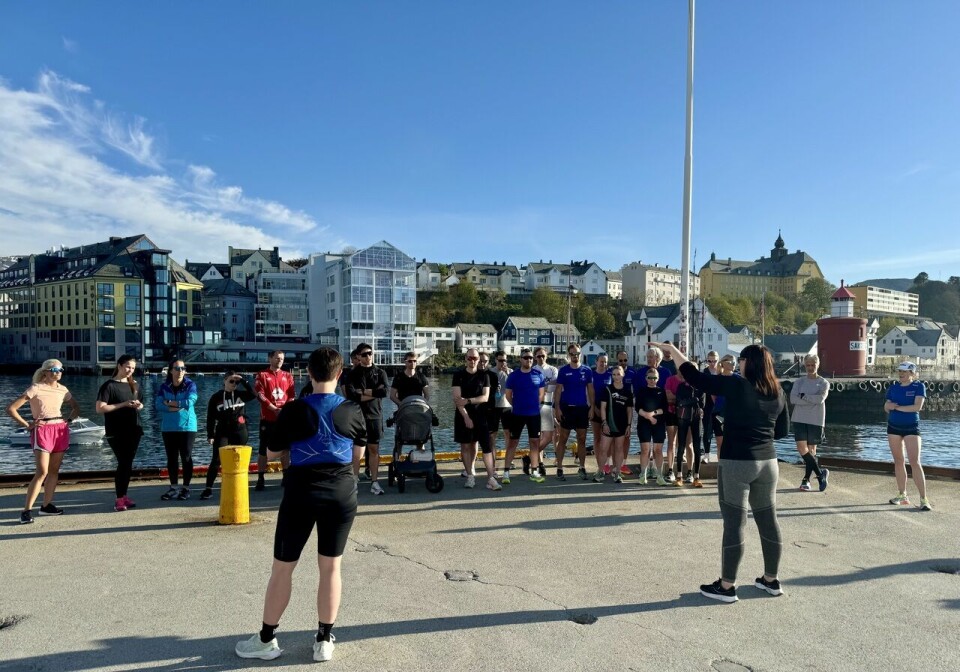 Monica Isaksen peker og forklarer løypen til Ålesund Maraton. Her fra startområdet null